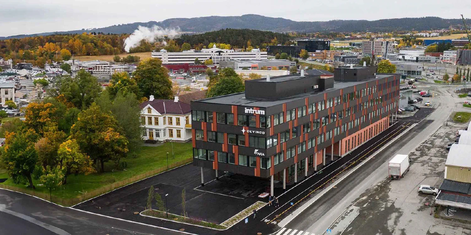 Drone photo of Indusenz offices, black building with rust red details